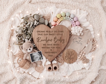 May include: A wooden heart-shaped sign with the text "Dreams really do come true our sweet little Rainbow Baby. We have been waiting for you. September 2025."  A wooden sign with the text "Hello Baby!" and a wooden sign with the text "Baby Carter".