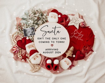 May include: A white wooden sign with the text "Santa isn't the only one coming to town! Arriving August 2024" surrounded by red and white striped fabric, red hearts, a small white and red Santa figurine, a small white and red baby Santa figurine, a small white and red baby bootie, a small white and red baby outfit, a small white and red star, and a small white and red candy cane.