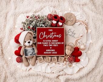 May include: A red and white Christmas-themed baby announcement with a sign that reads "This Christmas is extra sweet, our family is growing by two tiny feet! Arriving August 2025". There is a teddy bear holding an ultrasound image, a baby onesie, and other Christmas decorations.