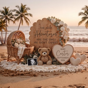 May include: A beach scene with a wicker baby carriage, teddy bear, and sign that reads "The Best Adventures Are The Ones We Didn't Expect." A heart-shaped sign says "Baby Carter September 2026." White flowers and a sonogram are also present.