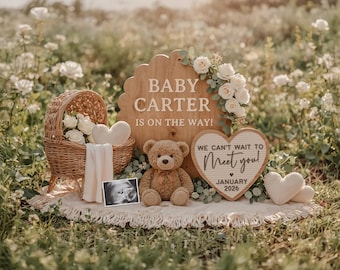 May include: A baby announcement scene with a wooden sign that reads "BABY CARTER IS ON THE WAY!" surrounded by white roses. A teddy bear, a wicker basket with flowers, and a heart-shaped sign that says "We can't wait to meet you!" are also present.
