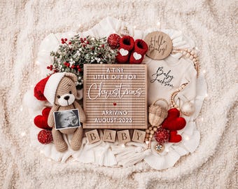 May include: A wooden letter board with the text "A tiny little gift for Christmas arriving August 2025". The board is surrounded by red hearts, a teddy bear holding an ultrasound image, a baby onesie, and wooden blocks that spell "Baby".