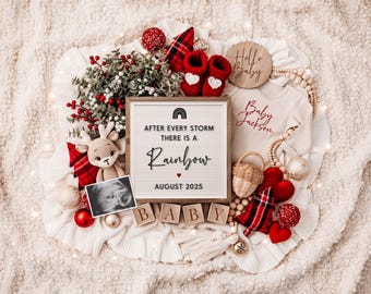 May include: A Christmas-themed baby announcement with a sign that reads "After every storm there is a rainbow, August 2025". The sign is surrounded by red and white plaid, red ornaments, a small stuffed reindeer, a baby onesie, and wooden blocks that spell "BABY".