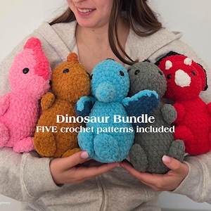 May include: A collection of five colorful, plush crochet dinosaur toys. The dinosaurs are in shades of pink, orange, blue, gray, and red. The text "Dinosaur Bundle" and "FIVE crochet patterns included" is visible.