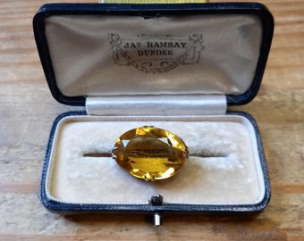 VICTORIAN CITRINE GLASS brooch in a rolled gold surround brooch