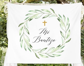 May include: White backdrop with a green watercolor wreath and a gold cross. The text "Mi Bautizo" is written in black cursive lettering inside the wreath.