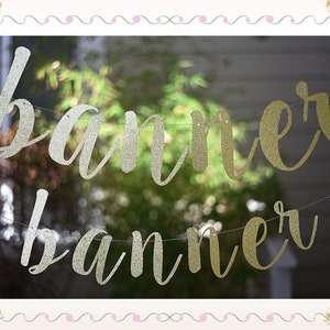 May include: A gold and silver glitter banner with the word "banner" written twice.