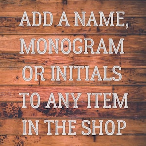 May include: White text on a wood background reads "Add a name, monogram or initials to any item in the shop."