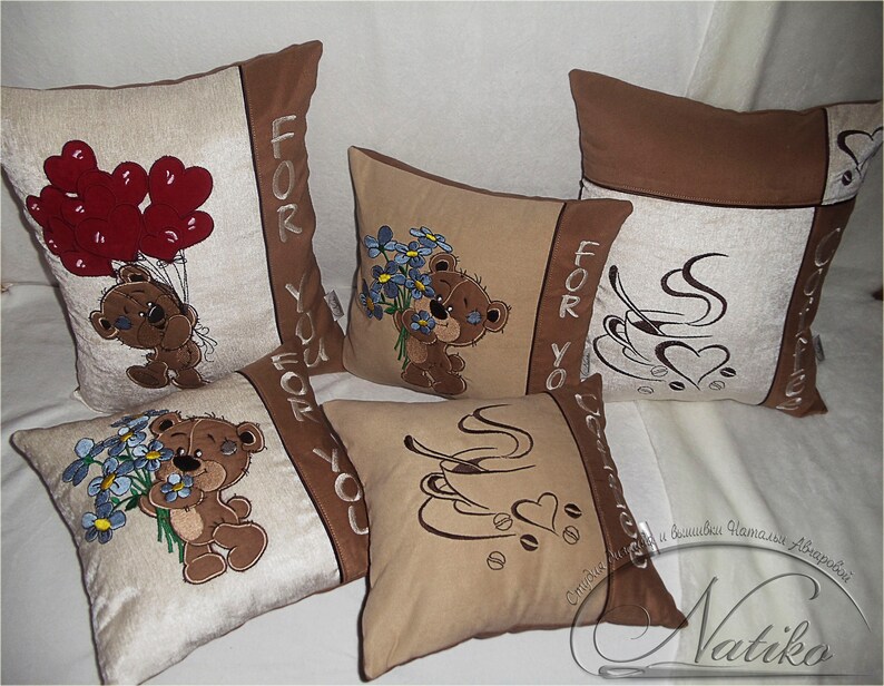 May include: Four decorative throw pillows with embroidered designs. Two pillows feature a brown teddy bear with a heart and a cup of coffee. One pillow has a teddy bear holding a bouquet of blue flowers. The last pillow has a teddy bear holding red balloons. All pillows have the text "For You" on them.