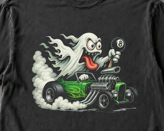 May include: A black t-shirt featuring a graphic of a white ghost with a red tongue driving a green hot rod car with yellow flames. The ghost is holding a black eight ball gear shift knob, and the car is surrounded by white exhaust smoke.
