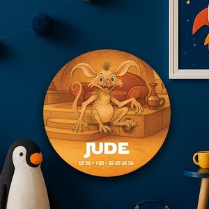 May include: A whimsical space-themed room with a blue wall, featuring a rocket ship print, astronaut plush, and a round sign with a creature illustration. Includes a small table with a tablet and a suitcase with a UFO design.