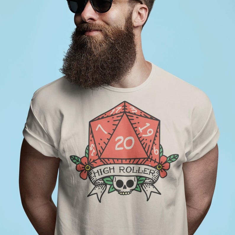 Unleash your inner rebel with our High Roller tee — where luck meets legend. Featuring a bold tattoo-inspired design, this shirt rocks a fierce skull entwined with a 20-sided die, symbolizing fate, risk, and relentless spirit. With vintage ink vibes and edgy detail, it’s perfect for tabletop warriors, dice slingers, and rule breakers. Wear it, roll high, and conquer every campaign in style.