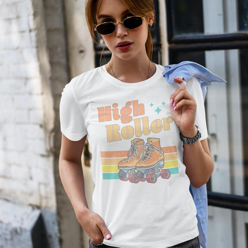 Get ready to roll in style with this retro 70s-inspired tee, featuring a funky, freewheeling design that screams disco lights, smooth moves, and good vibes! Whether you’re cruising the rink, hitting the streets, or just vibing, this tee is perfect.