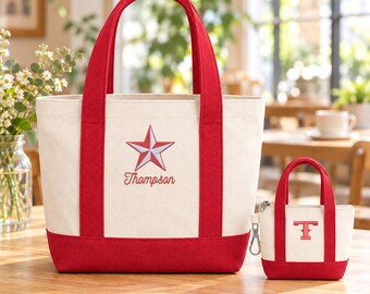 May include: A large off-white canvas tote bag with red trim, handles, and a red star emblem above the embroidered name Thompson. Beside it sits a matching miniature canvas pouch with red trim and a red letter T, featuring a silver metal clip.