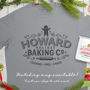 May include: A gray t-shirt with a vintage-style logo that says "Howard Holiday Baking Co." with a gingerbread man, rolling pin, and the words "Cookies, Pies, Cakes". A matching white mug with the same logo is also shown. The text "Matching mug available! Visit our shop to see more" is at the bottom of the image.