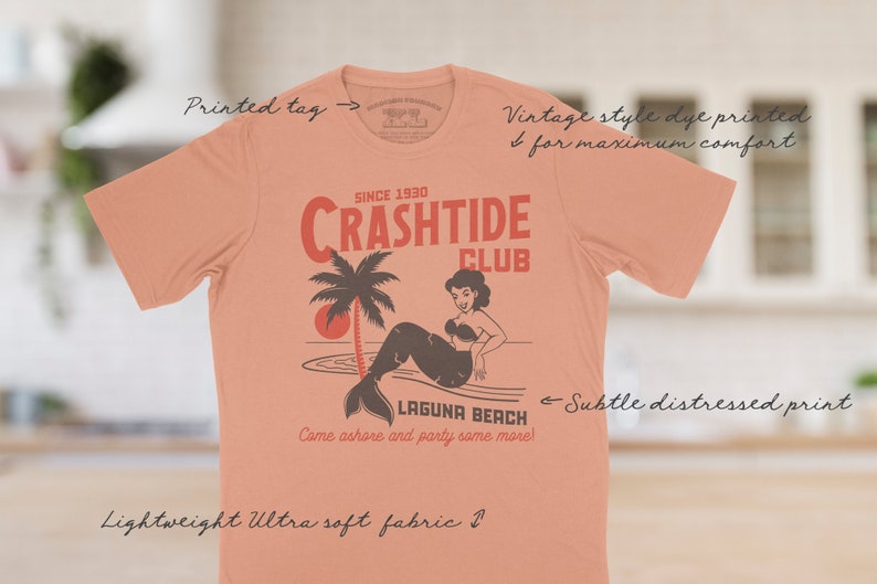 The Crashtide Club tee has a vintage distressed design. These shirts are so buttery soft and comfy that you will want to wear it year round.  The designs and tags are dye printed for  comfort. The shirts are available in many sizes and colors.