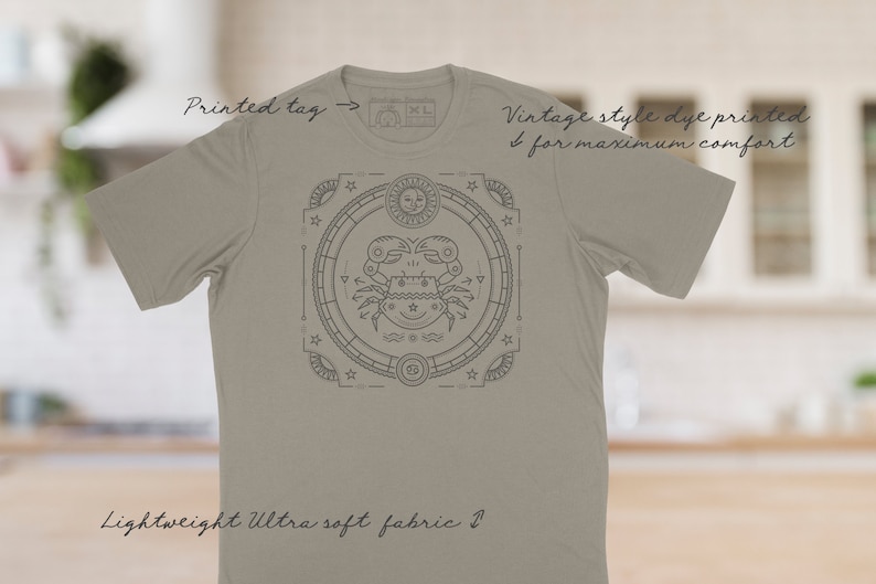 Puede incluir: Una camiseta gris claro con un dise&ntilde;o de impresi&oacute;n de tinte de estilo vintage que presenta un s&iacute;mbolo del zod&iacute;aco de cangrejo en un c&iacute;rculo con estrellas y otros s&iacute;mbolos. La camiseta tiene una etiqueta impresa que dice "XL".