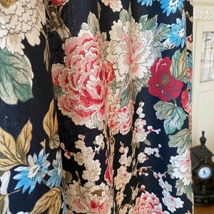 May include: Dark navy floral curtains with large, detailed blooms in shades of pink, red, white, and blue. The curtain fabric features a classic botanical design with green leaves and stems, creating a vintage aesthetic.