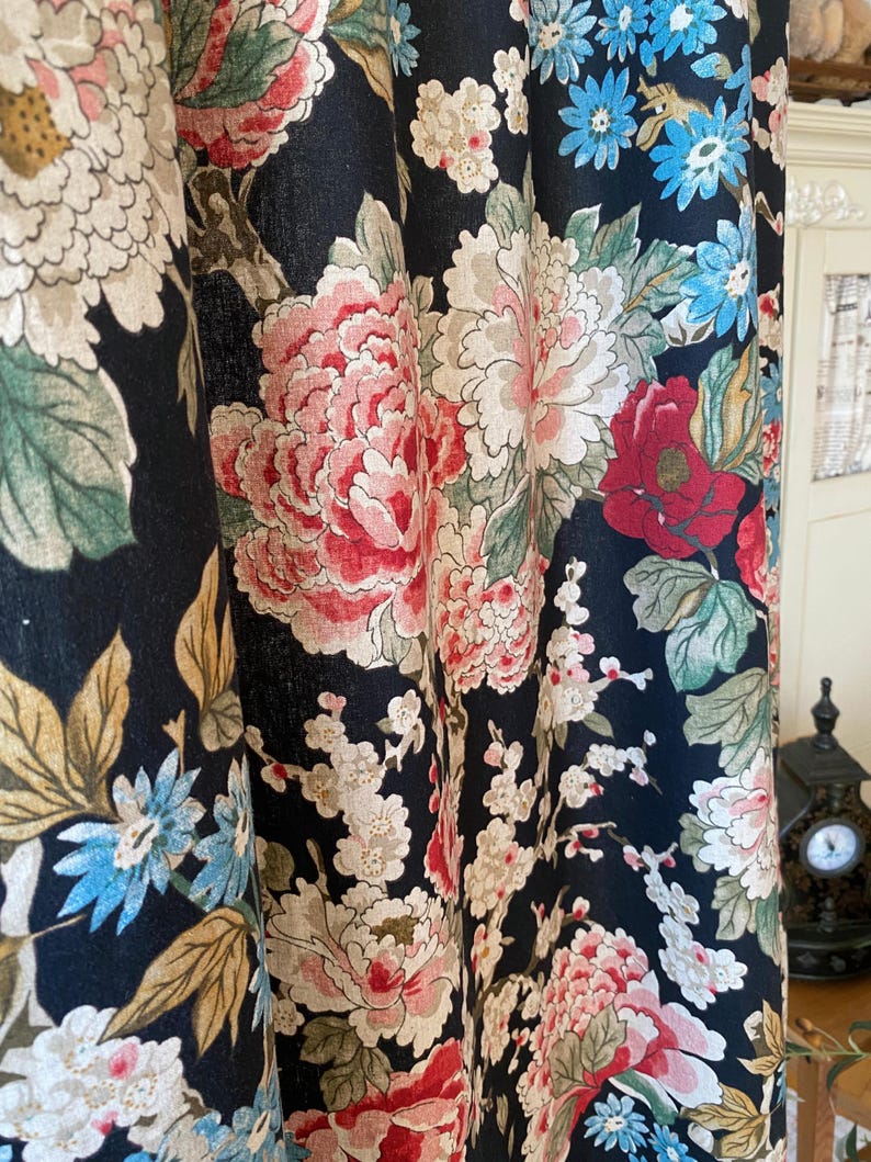 May include: Dark navy floral curtains with large, detailed blooms in shades of pink, red, white, and blue. The curtain fabric features a classic botanical design with green leaves and stems, creating a vintage aesthetic.