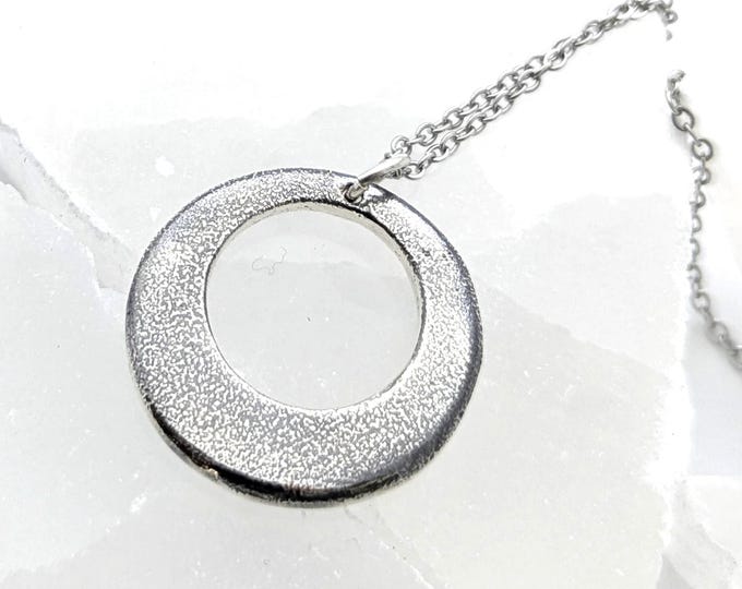 Silver eclipse pendant; sandcast, unisex jewellery, necklace
