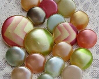19 vintage waxed glass knobs, collector's items, 11 mm - 18 mm, silky smooth surfaces in yellow, red, and green tones, some with geometric designs.