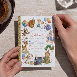 May include: A colorful invitation with a whimsical design for a first birthday. The invitation features illustrations of various animals, balloons, and confetti. The text reads "Madeline's FIRST CHAPTER" with event details.