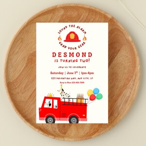 May include: A birthday party invitation featuring a red fire truck with a Dalmatian dog driving. The invitation reads "DESMOND IS TURNING TWO!" with event details and a call to "SOUND THE ALARM, GRAB YOUR GEAR."