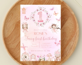 May include: A pink fairy-themed first birthday invitation with the number 1 in the center, surrounded by a floral wreath. The invitation includes illustrations of fairies, butterflies, and fairy houses. Text reads "Rosie's Fairy first birthday".