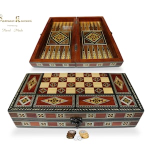 May include: A wooden backgammon and chess game set with intricate inlaid designs. The set is closed and features a brown, red, and black colour scheme. The set includes dice and playing pieces.