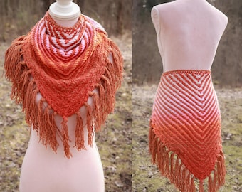 Handwoven triangle shawl made from yarn scraps in pink and orange gradient.