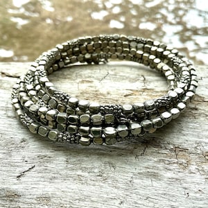 May include: A white ceramic mug with a black handle and the text "But First, Coffee" in a handwritten style. The mug is likely 12-16 ounces, perfect for a morning beverage.