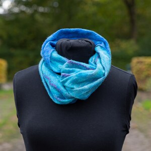 Nuno felted loop scarf, with silk and merino wool, different shades of blue with silk accents of violet, infinity scarf.