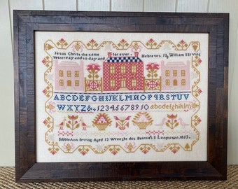 May include: A framed cross-stitch sampler with a white background and colorful embroidery. The sampler features a quote from the Bible, "Jesus Christ the same Yesterday and to day and for ever." It also includes the alphabet, numbers, and the text "Hebrews 13 William Sirving." The sampler is signed "Sibble Ann Irving Aged 13 Wrought this Beattie'ss Longtown 1853."