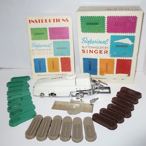 May include: A white Singer Professional Buttonholer sewing machine with a set of attachments, including a foot pedal, a guide, and various sized buttonhole plates. The machine is on a white surface with a green and brown buttonhole plate set, and a set of instructions.