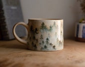 Pottery mug with foggy forest.