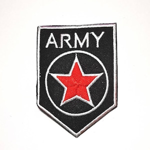 May include: Black and white embroidered patch with the word "ARMY" at the top. A red star is centered within a white circle, all on a black background. The patch has a shield shape with a white border.