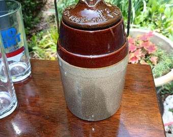 Hand turned stoneware crock with wire bale handle circa 1902