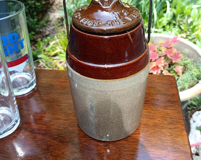 Hand turned stoneware crock with wire bale handle circa 1902