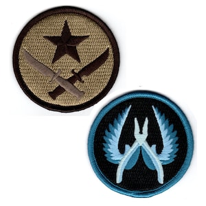 May include: Two embroidered patches, one with a brown star and crossed knives on a tan background, the other with a white winged symbol on a black background with a blue border.