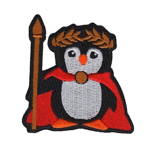 May include: Iron-on patch featuring an embroidered penguin wearing a red cape and a gold laurel wreath, holding a brown spear.