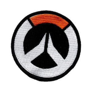 May include: A white and black Overwatch logo patch with an orange accent. The logo is a stylized peace sign with a black center.