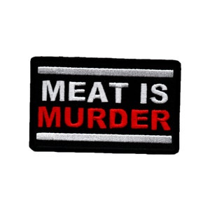 May include: Black and white embroidered patch with the text "MEAT IS MURDER" in red and white lettering.