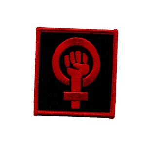 May include: Red embroidered patch with a raised fist inside a female symbol on a black background.