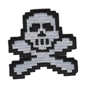 May include: A white pixelated skull and crossbones design embroidered on a black fabric patch.