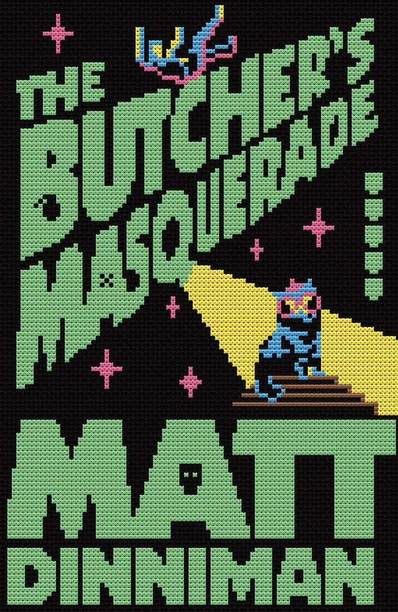 May include: Black cross-stitch design featuring the text "THE BUTCHER'S MASQUERADE" in green pixelated letters, with the name "MATT DINNIMAN" below. A pixelated figure is illuminated by a yellow spotlight. Pink star accents are scattered throughout.