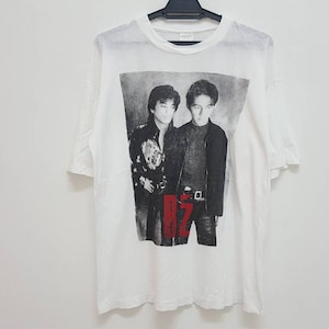 May include: White t-shirt with a black and white photo of two men. The men are wearing black clothing and the text "RZ" is printed in red on the shirt.