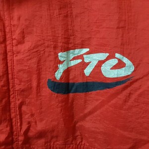 May include: Red jacket with a white and black logo that says "FTO" on the front.