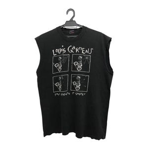 May include: Black sleeveless t-shirt with white graphic print. The print features the text "LOUIS GARNEAU" above four square images with abstract drawings. Below the images is the text "FOR SEASON'S 1st SUFFER". The shirt is hanging on a black hanger.
