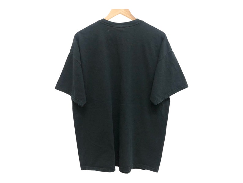 May include: A black short-sleeved t-shirt with a crew neck.