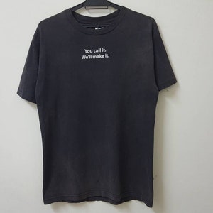 May include: A black t-shirt with the text "You call it. We'll make it." printed in white on the front.